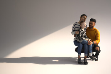 Woman man and child sitting together smiling.