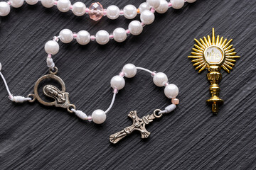 Golden brooch, Golden religious symbol with IHS monogram and Catholic rosary