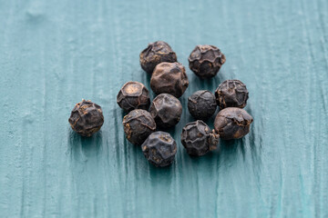 Organic black peppercorns scattered - Piper nigrum