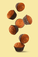 Falling cupcakes on light yellow background.


