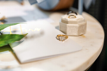 An elegant close-up of a radiant engagement ring resting on a wedding vow book — a timeless symbol of love, promise, and the beginning of forever, captured in soft, golden light