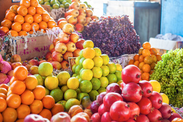 Bright colourful fruits: apples, oranges, grapes ,- on the indian street market