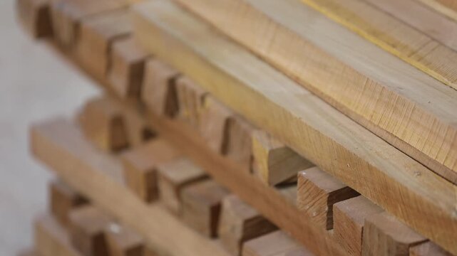 Vintage wooden letterpress blocks and tools stacked on a shelf in a workshop. Represents traditional printing, craftsmanship, typography, and history of media.