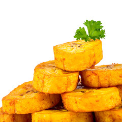 Stacked golden fried plantain slices with a parsley sprig