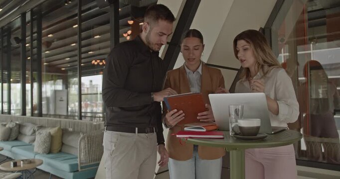 Professional business partners review strategies and celebrate a significant achievement. Their collaborative teamwork highlights the successful growth and expansion of their small business.