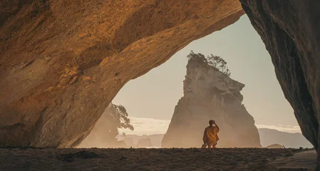 Acrylglasbilder Cathedral Cove Traveler in cave at Cathedral Cove, New Zealand at sunrise  © Louis Letort