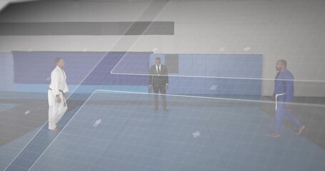 Referee in suit directing fighters standing on gym mat, with white gi and blue gi