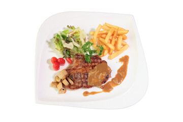 A delicious and appetizing steak served on a white plate, complete with fries and salad