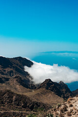 Beautiful vertical view of mountain ranges with clouds.