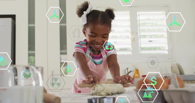 Girl placing hands on dough, rolling with pin and flattening for cooking as eco icons drifting