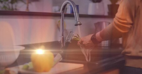 Home cook turning chrome kitchen faucet and rinsing asparagus under flowing water for cooking - Powered by Adobe