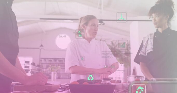 Chef using hand gestures initiating green icons guiding team slicing vegetables for culinary demo