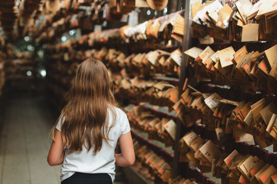 Girl walking along lines of prayer cards (ema)