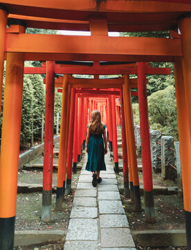Girl walking through a path of Tori gates