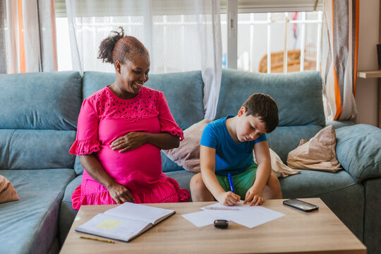 A pregnant woman teaching several subjects at home