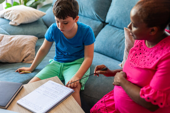 A pregnant woman teaching several subjects at home