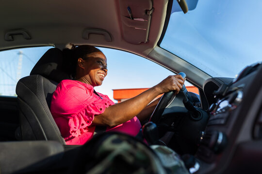 mature woman smiling in her car