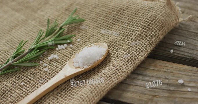 Numeric codes drifting from right starting camera panning zooming focusing salt spoon and rosemary