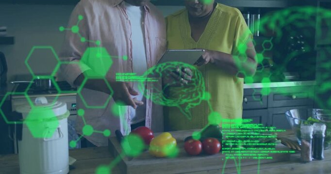 Senior couple leaning toward tablet activating green molecular code overlay for healthy meal prep