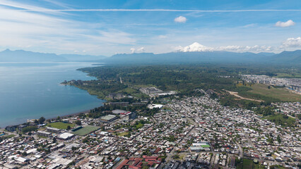 Aerial view of the city of Villarrica, Araucanía, Chile. Villarrica volcano in the background.