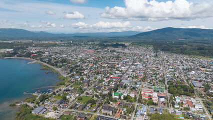 Aerial view of the city of Villarrica, Araucanía, Chile. Villarrica volcano in the background.