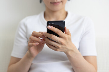Close-up of smartphone held by woman