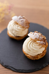 Cream puffs with whipped cream filling on a white plate
