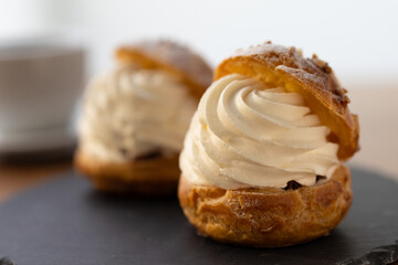 Cream puffs with whipped cream filling on a white plate