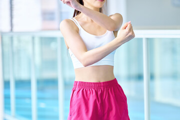 ジムでストレッチする女性の上半身