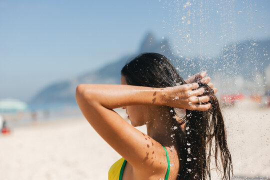 Woman Rinsing Hair in Beach Shower
