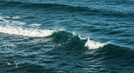 Fototapeta premium Deep ocean water displays a prominent wave cresting with white foam