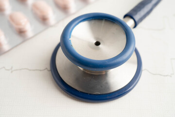 Stethoscope on electrocardiogram ECG with drug, heart wave, heart attack, cardiogram report.