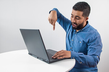 Excited Man Pointing Down at Laptop Screen
