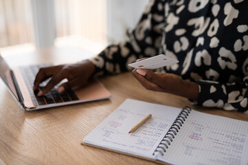 Woman entering credit card details on laptop
