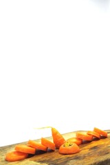 The fresh orange carrots or daucus carota on an old wooden chopping board