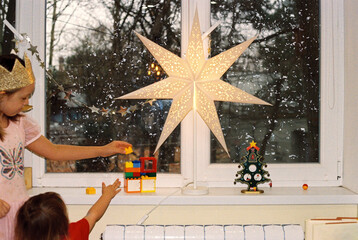 Children decorating their room on Christmas Eve.