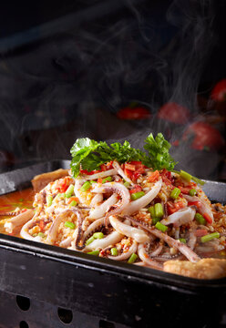 Wok-fried squid tentacles with spicy garlic sauce, close-up