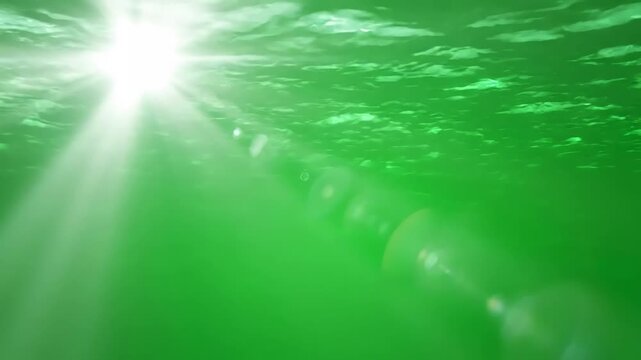 Abstract Digital Backgrounds with sun rays on green screen from top view beautiful white spotlight effects moving underwater sea scene flash lights bright light lens flare effect chroma key 4k