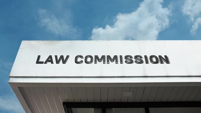 Law Commission word sign displayed on building facade under clear blue sky, representing legal reform, legislative review, and the development of modern statutory frameworks.
