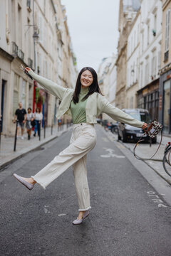 Joyful woman posing in Paris street