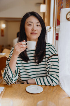 Woman enjoying coffee at caf&eacute;