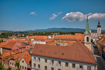 Fototapeta premium Zagreb, Croatia – July 18, 2025: Panoramic view of Zagreb’s cityscape with its iconic terracotta rooftops, a mix of historic and modern buildings, and distant high-rises on the horizon 