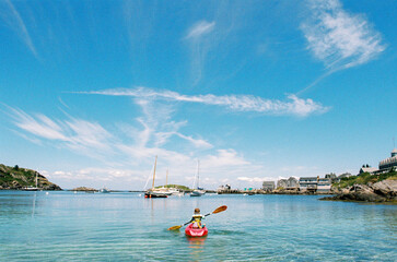 Boy paddles child-sized kayak 
