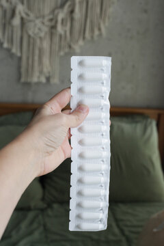 Female holding Progesterone Suppository