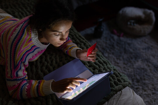A girl enters credit card data into a tablet