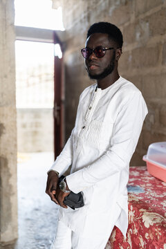 Senegalese man wearing traditional boubou and sunglasses