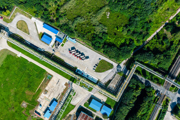 Aerial view of industrial parking lot with lined up cargo trucks