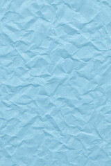 Fototapeta premium Crumpled baby blue paper with rough texture background. Simple, abstract, wrinkled surface providing solid pastel color backdrop for design and empty copy space