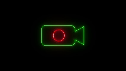 Bright neon green camera icon with a red record button glows in the dark symbolizing video recording and filmmaking