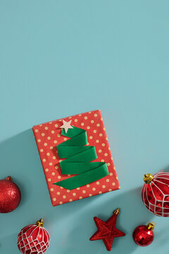 A beautifully wrapped gift with a red ribbon on blue background